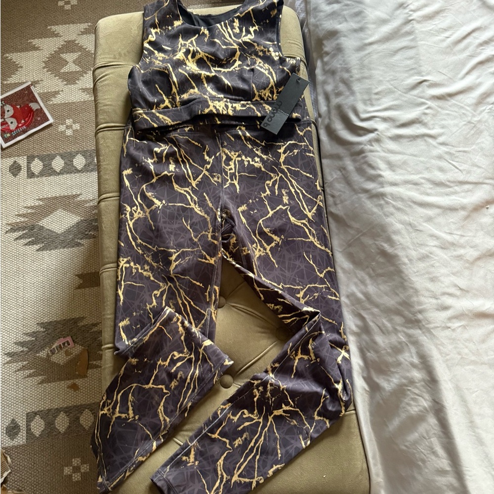 Stylish Black and Gold Women's workout wear pants and top with keyhole back.